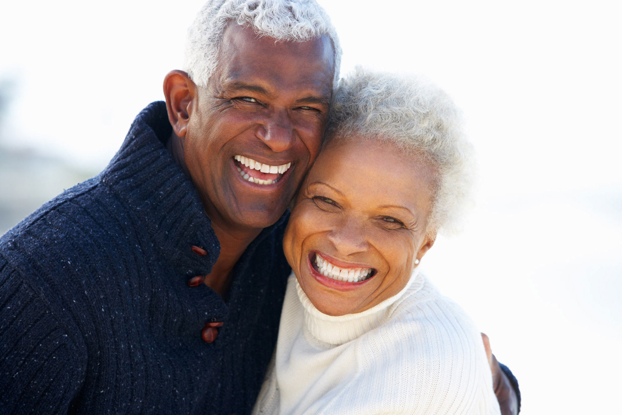elderly couple hugging and smiling